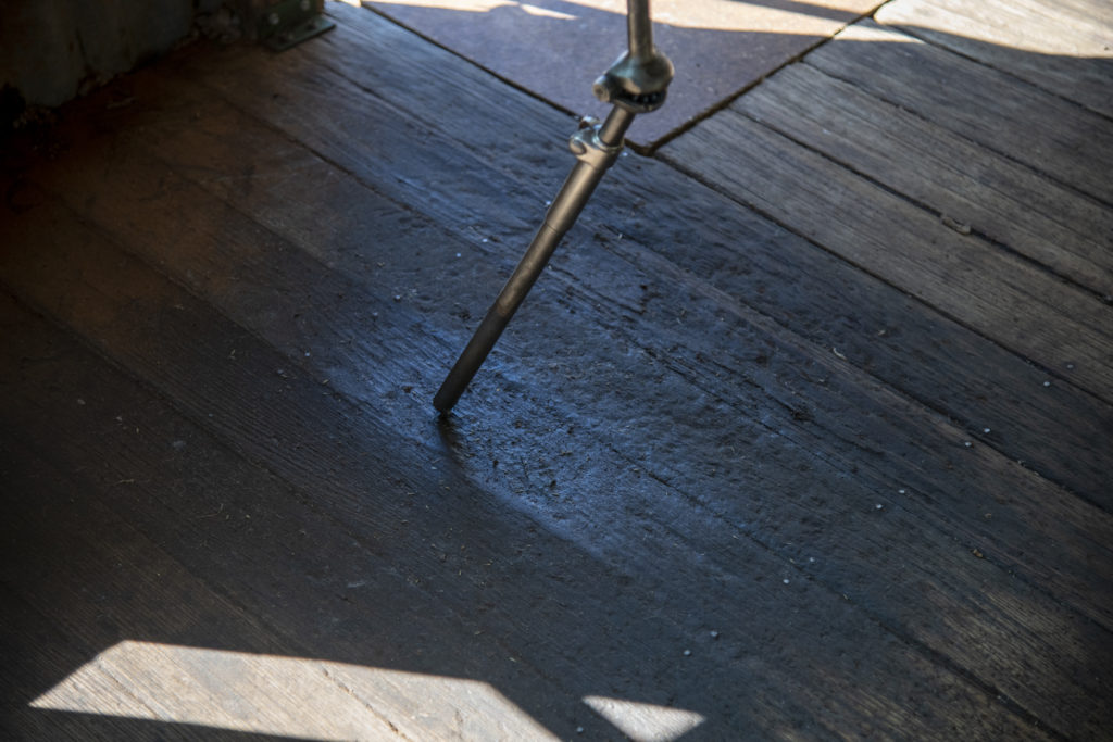 Shearing blade shaft resting on lanolin stained timber floor